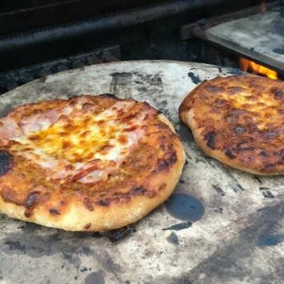 Pizza outdoors on a pizza stone